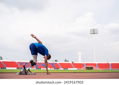 Asian para-athletes disabled with prosthetic blades running at stadium. Attractive amputee male runner exercise and practicing workout for Paralympics competition regardless of physical limitations. - Powered by Shutterstock