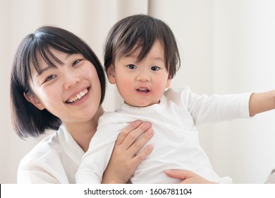 Asian Parent And Child In The House