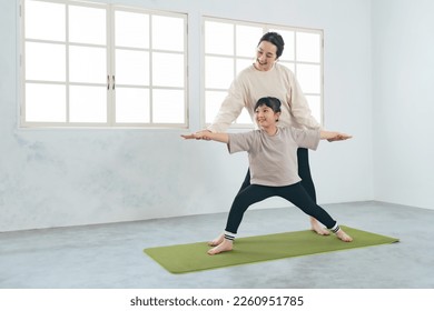 Asian parent and child practicing yoga. - Powered by Shutterstock