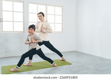 Asian parent and child practicing yoga. - Powered by Shutterstock