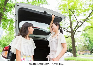  Asian Parent And Daughter And Car