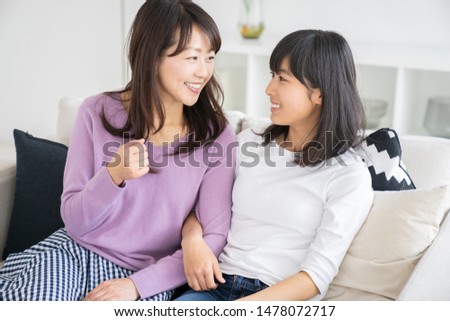 asian parent and daughter who is relaxed