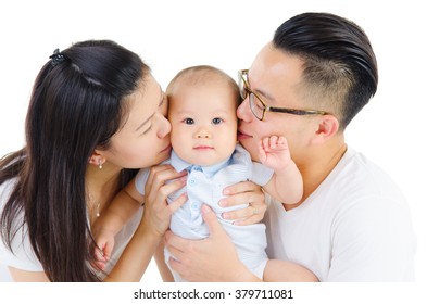 Asian Parent Kiss Their Baby On White Background