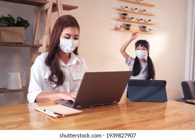 Asian Parent Mother Working At Home With Daughter Study Online Class Wearing Protective Surgical Face Mask From Coronavirus Covid-19 Pandemic Family Lifestyle, Tablet Laptop Technology Video Call