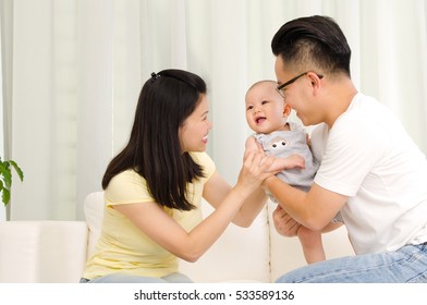 Asian Parent Playing With Their Baby Boy