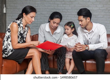 Asian Parent talking with teacher about Plan education for children. Young family and children discuss or advice with professional family psychologist in office
