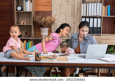 Asian parent working while looking after a young baby or toddler, single mother businesswoman working from home multitask nursing infant using technology modern laptop meeting online at home office