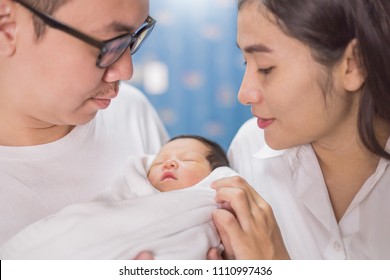 Asian parents with newborn baby, Close up portrait of asian young couple father and mother holding their new born baby. Happy family love newborn nursery mother’s day holiday concept