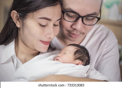 Asian Parents With Newborn Baby, Close Up Portrait Of Asian Young Couple Holding Their New Born Baby. Mother's Day Concept