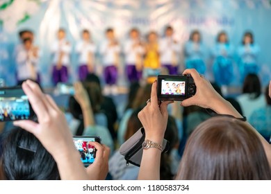 Asian Parents Recording Video And Photo Shooting In Their Kids School Event, Bangkok, Thailand.