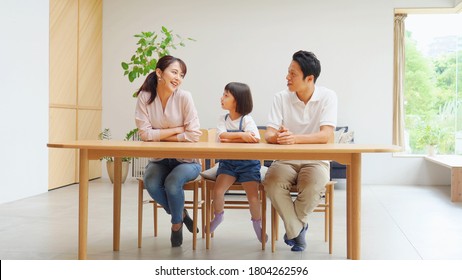 Asian Parents Talking With The Daughter At Home