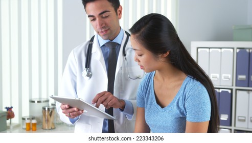 Asian Patient Talking With Her Doctor About Her Test Results