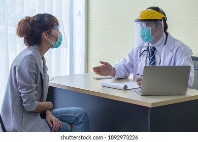 Asian Patient Wearing A Covid19 Protective Mask, Meets A Doctor, Wears A Surgical Mask And Talks To A Patient In The Hospital.