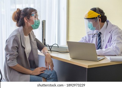 Asian Patient Wearing A Covid19 Protective Mask, Meets A Doctor, Wears A Surgical Mask And Talks To A Patient In The Hospital.