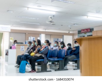 Asian Patients Wear Face Mask Waiting For Seeing Doctor In The Hospital , On Blurred Background.