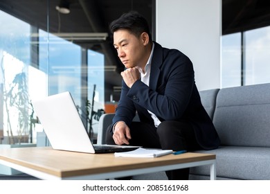Asian Pensive Businessman At Laptop, Thinking About Creating A New Business Strategy, Successful Man Working On Laptop At Office