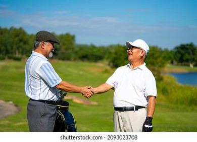 Asian people businessman and senior CEO shaking hand after finish talking business project and game at golf course. Elderly male friends golfer enjoy outdoor sport golfing together at country club. - Powered by Shutterstock