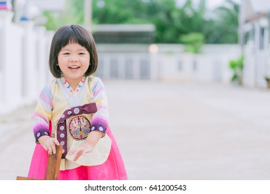 Asian people concept.Smile Korean little girl wearing a Traditional Hanbok in playground - Powered by Shutterstock