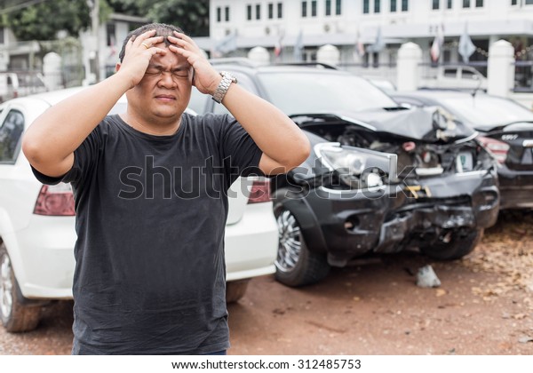 Asian people of\
desperate man after car\
crash