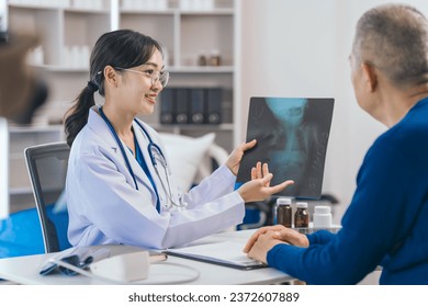 Asian people experienced female doctor giving advice to elderly male patient cancer and x-ray results and treatment options, Cancer Consultation, Elderly Man Receives Expert Cancer Advice Awareness - Powered by Shutterstock