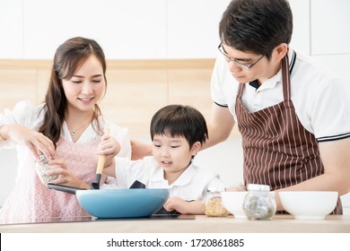 Asian People Family Standing Smile Happy Preparing Cooking Together In Modern Design Kitchen Room With Copy Space, Parent And Kid Is Real People Family.