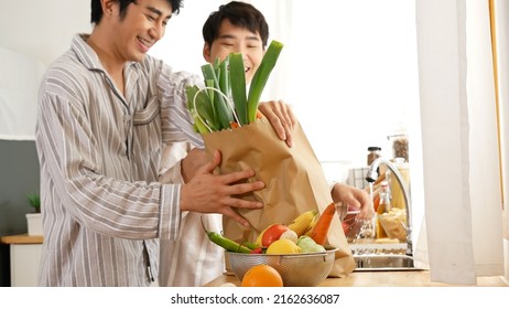 Asian People Happy Time Smile, Laugh In Kitchen. Best Friend LGBTQ Lifestyle. Happy Asian Gay Couple Homosexual Cooking Together In Kitchen Prepare Fresh Vegetable Make Organic Salad Healthy Food.