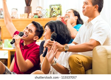 Asian People Singing At Karaoke Party And Having Fun