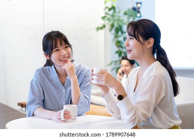 Asian people talking happily indoors - Powered by Shutterstock