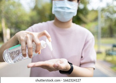 Asian people using alcohol antiseptic gel and wearing prevention mask,prevent against infection of Covid-19 outbreak,woman washing hands with hand sanitizer to avoid contaminating with Corona virus   - Shutterstock ID 1662324127