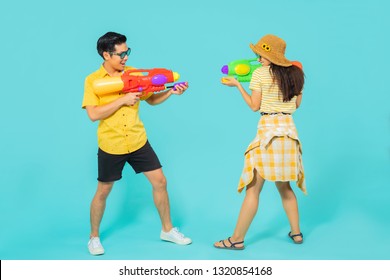 Asian people are using water guns play in the Songkran festival. Studio concept
