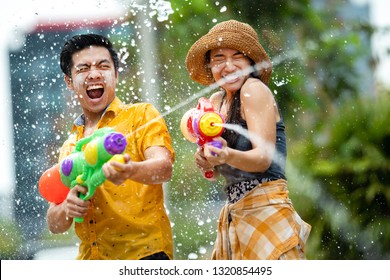 Asian people are using water guns play in the Songkran festival