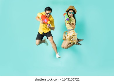Asian people are using water guns play in the Songkran festival. Studio concept