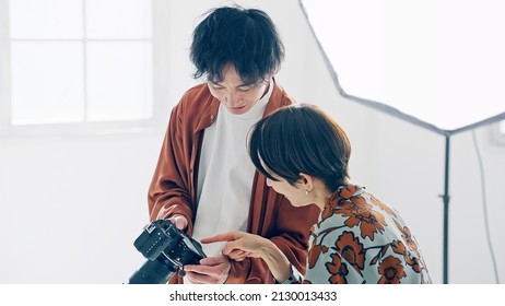 Asian people watching LCD of camera in the shooting studio. - Powered by Shutterstock