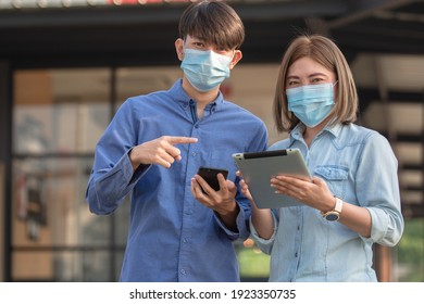 Asian people wear face mask and use tablet smartphone walking street urban Then mask for protect coronavirus covid19  - Powered by Shutterstock