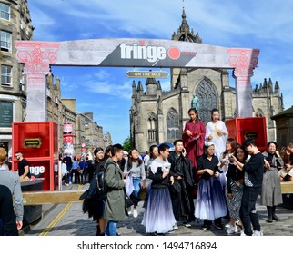 Asian Performers Standing Under The Fringe Banner Sign At The Annual Edinburgh Festival, A Month Long Arts Celebration In Edinburgh Scotland UK. AUGUST 2019