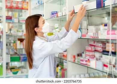 Asian Pharmacist Woman With Protection Mask In Pharmacy Store Of Her Business For Sale A Drug And Pharmacy With Her Customer