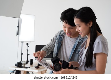 Asian photographers and models are talking about the reference images that customers need. This picture describes the work of a photographer in a studio, professional photography studio concept. - Powered by Shutterstock