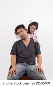 Asian Physiotherapist Doing Physiotherapy For Asian Middle Aged Male Patient Isolated On White Background. Health Care Concept.