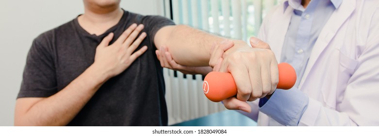 Young Asian Physiotherapist Helping Male Patient Stock Photo (Edit Now ...