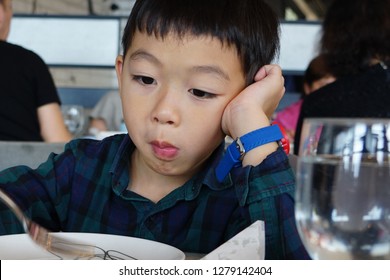 An Asian Picky Eater Boy With Boring Expression.    