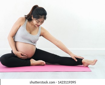 Asian pregnant woman doing yoga at home, lifestyle concept.