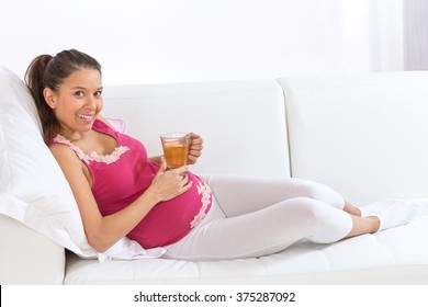 Asian  Pregnant Woman Has A Rest At Home  With Cup Pf Tea