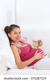 Asian  Pregnant Woman Has A Rest At Home  With Cup Pf Tea