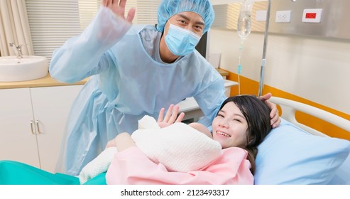 Asian Pregnant Woman Smiling At You In Delivery Room Is Giving Birth Successfully - She Hugging Their Baby With Husband In Hospital