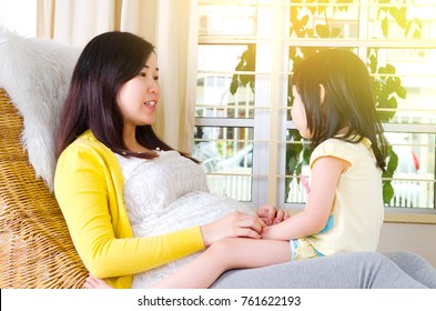 Asian Pregnant Woman Talking To Her Daughter