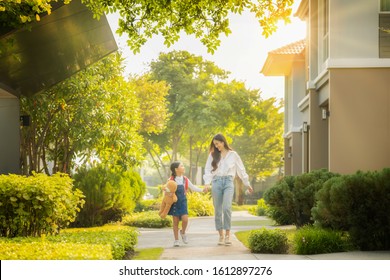 Asian preschool girl walk with her mother to go to school with gardent in morning time background - Powered by Shutterstock