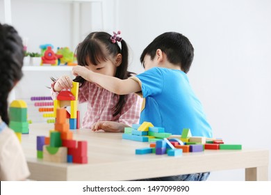  Asian Preschool Student Build Block Toys At Home Or Daycare. Cheerful Kid Playing With Color Cubes. Educational Toys For Preschool And Kindergarten Children.