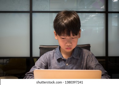 An Asian Preteen Student Learning To Code Programming Language Using Laptop. Kids Coding & Programming Concept