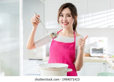 Asian pretty housewife cook healthy meal at home and thumb up - Powered by Shutterstock