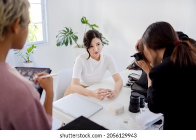 Asian pretty model , photographer and stylish shooting product fashion set together in studio setup. - Powered by Shutterstock